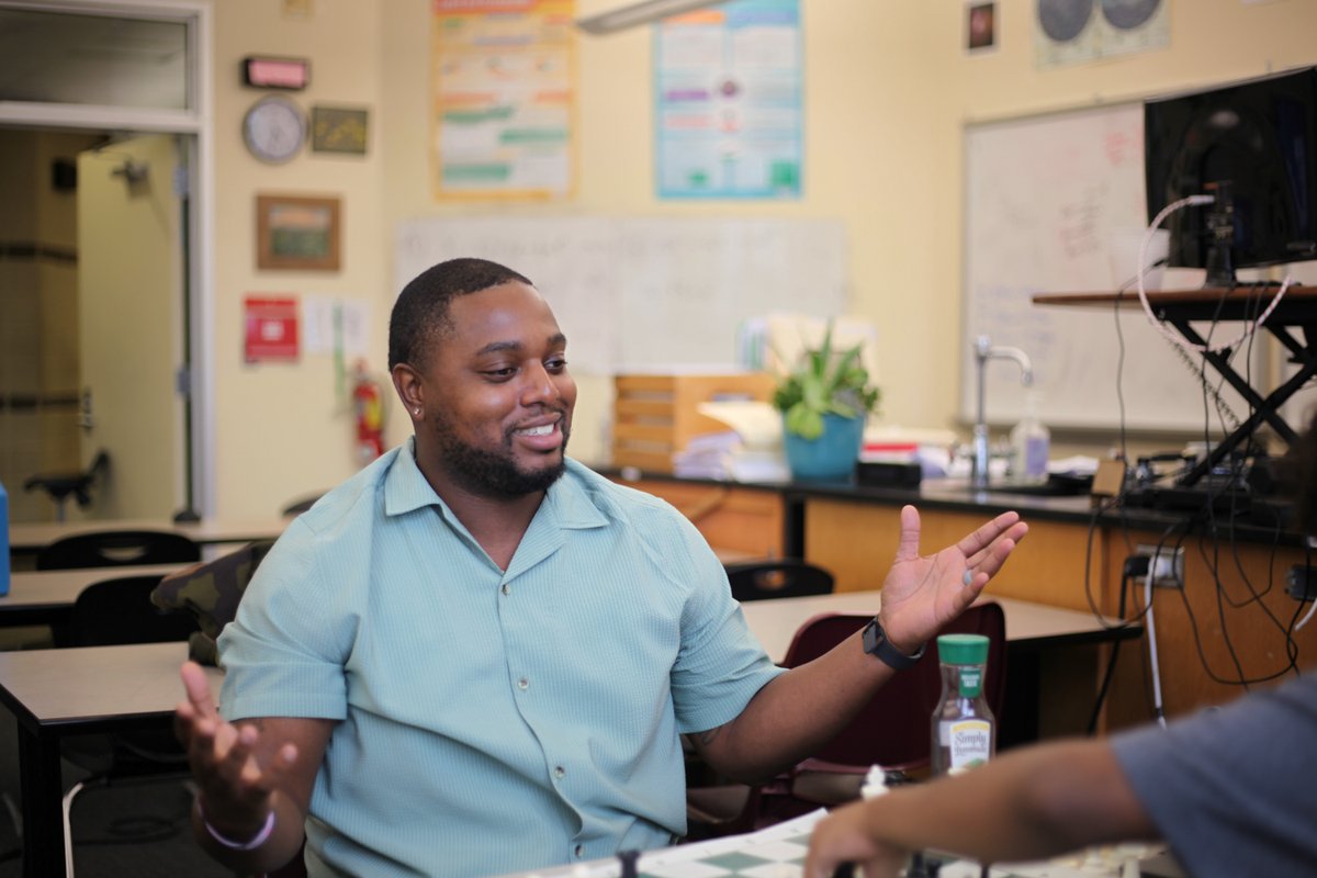 Candid portrait of a man gesturing in a classroom
